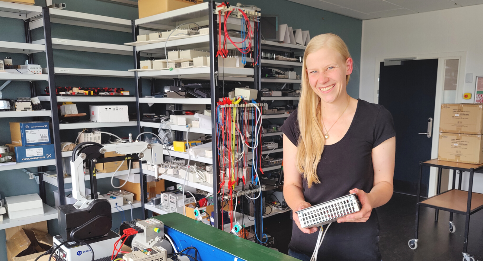 Frederikke, der står med en PLC i hånden, vil læse automationsteknolog i Randers