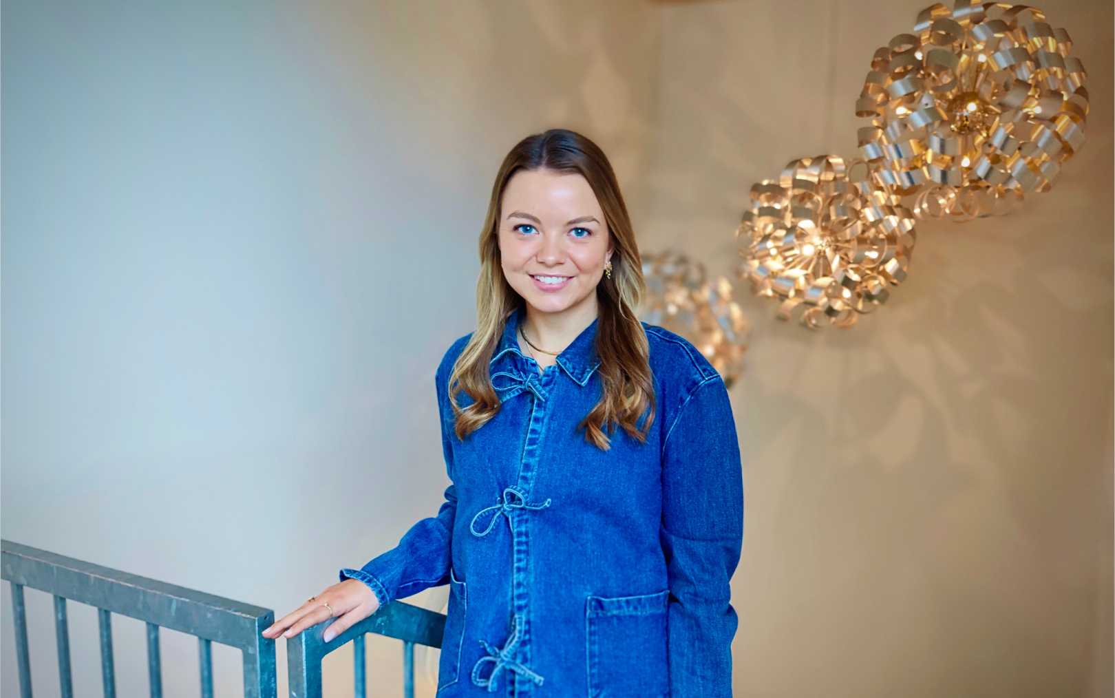 Trine, der læser til handelsøkonom på Erhvervsakademi Dania, står på trappen til Lead Company i Randers