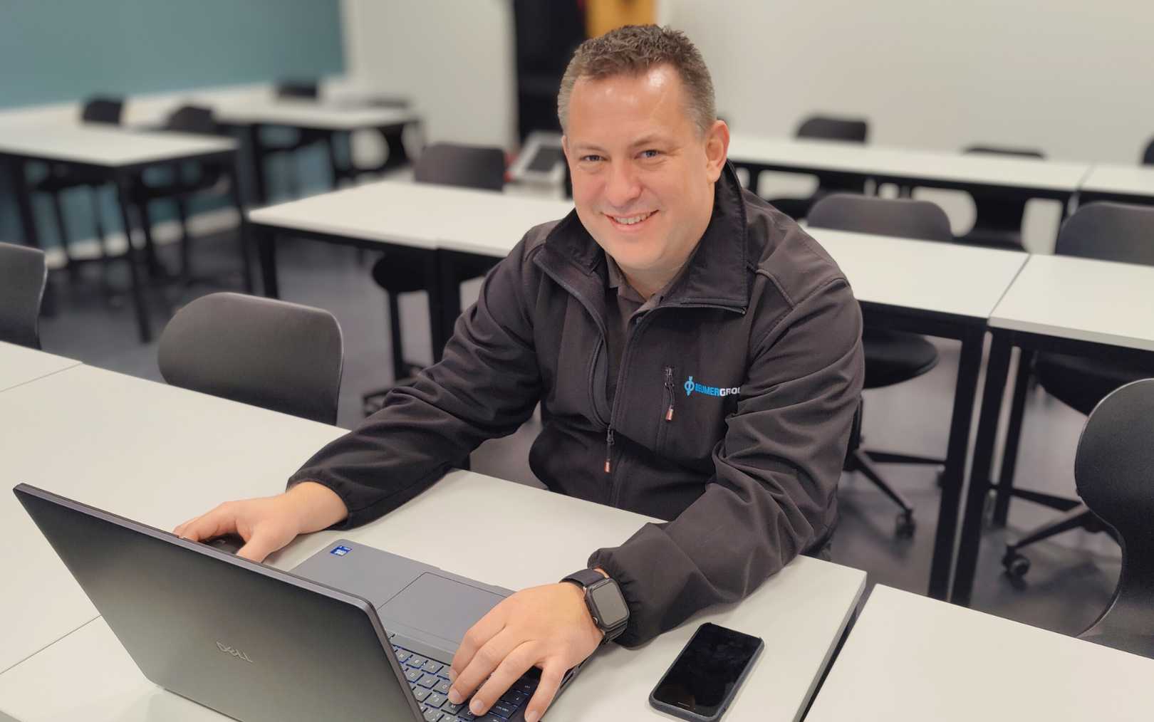 Joakim, der læser drift og automation på Erhvervsakademi Dania, hvilket er det samme som en automationsteknolog-uddannelse på deltid, sidder ved sin computer i et lokale på Dania